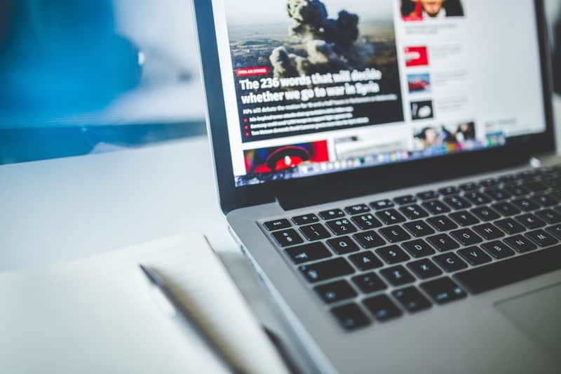 news website open on a macbook pro