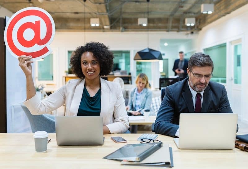 Business Woman Holding an @ Sign