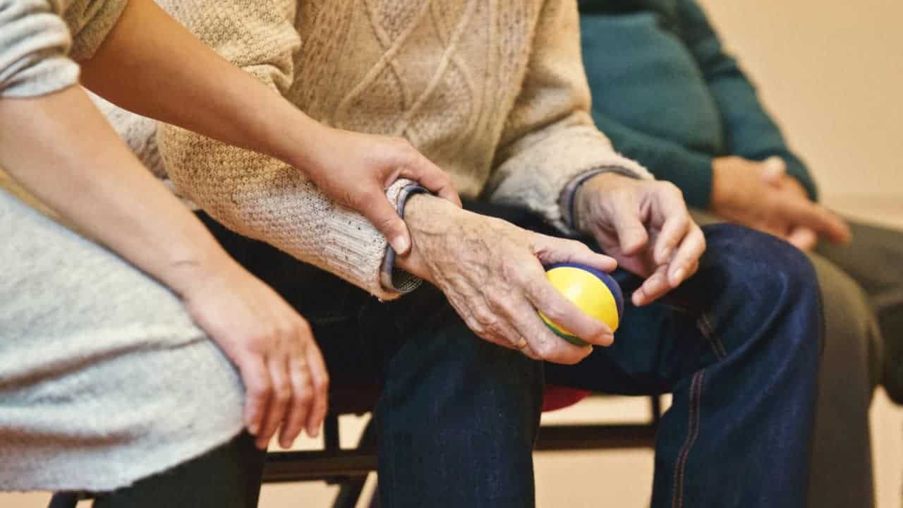 adult holding a stress ball