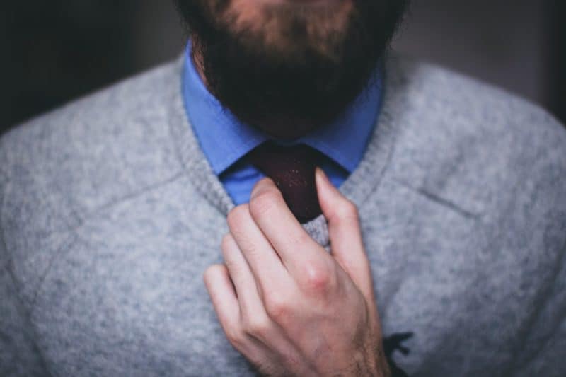 business man fixing his tie