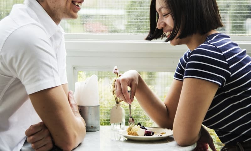 man and woman on a first date inside a restaurant