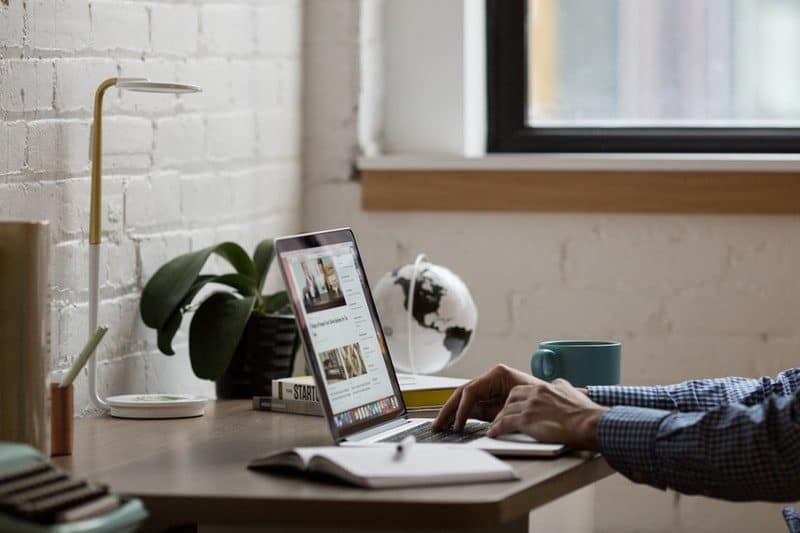 man using his laptop at the office