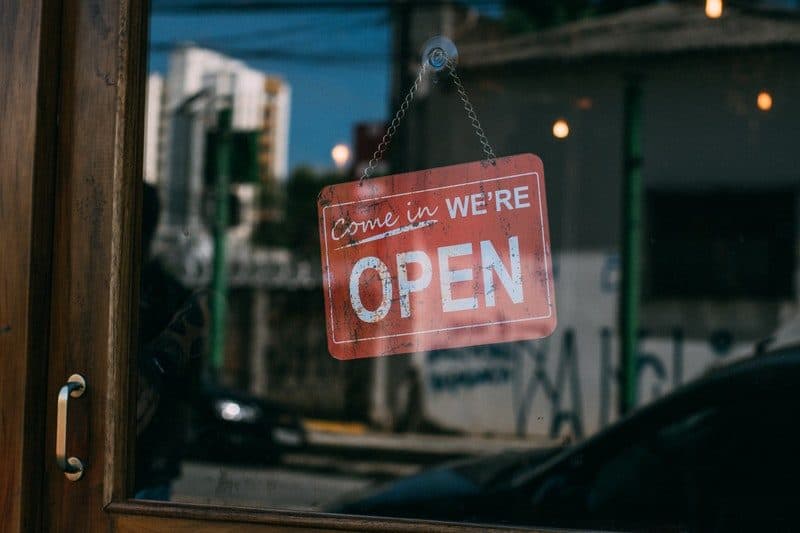 Come in we are open sign hanging inside a small shop