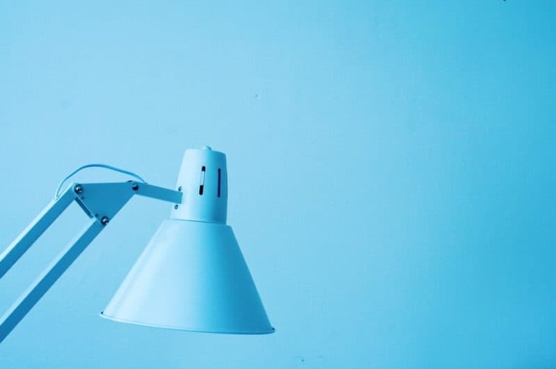 blue desk lamp against a blue wall