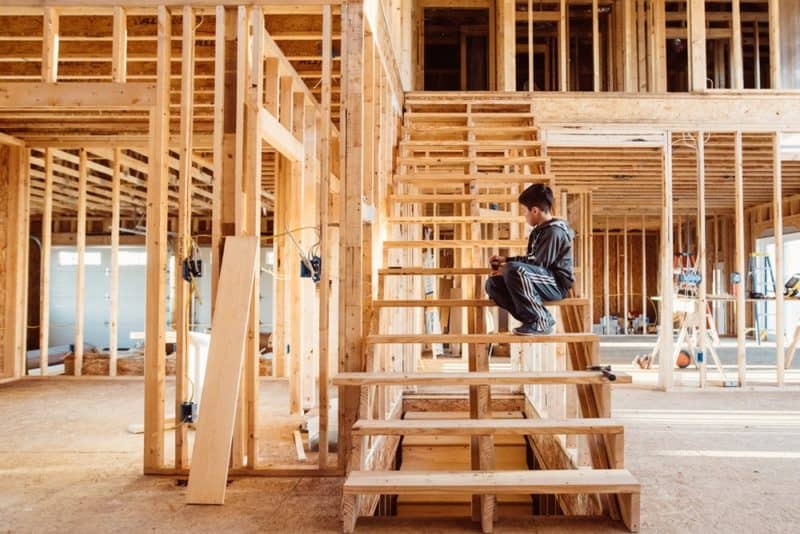 boy sitting on wooden stairs