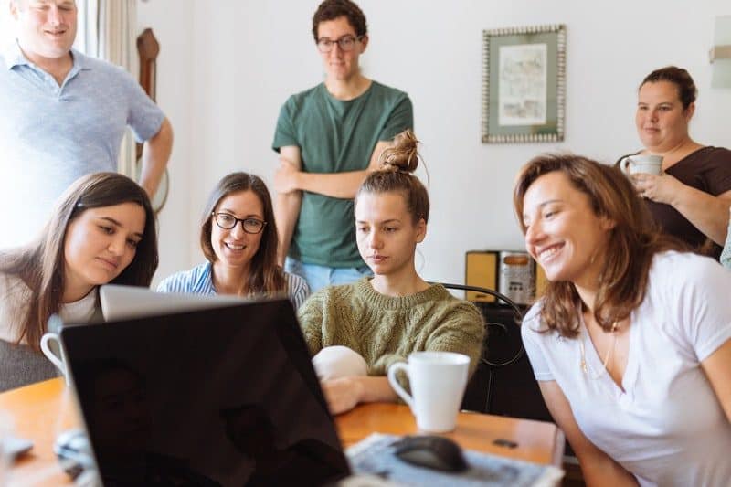 family and friends looking at a laptop