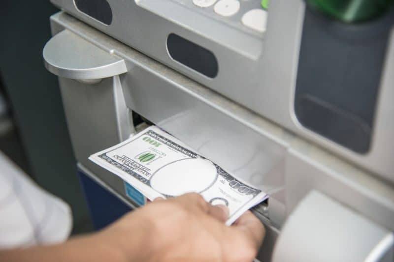 person pulling money out from an ATM