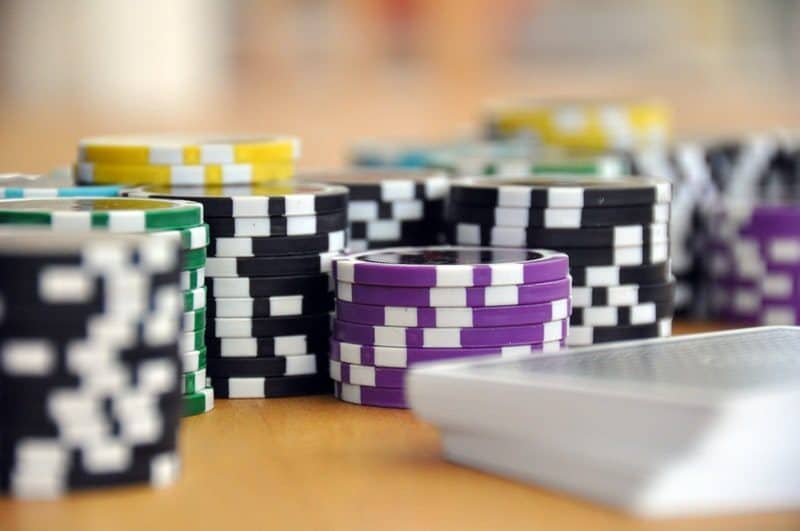 poker chips laying on a wooden table