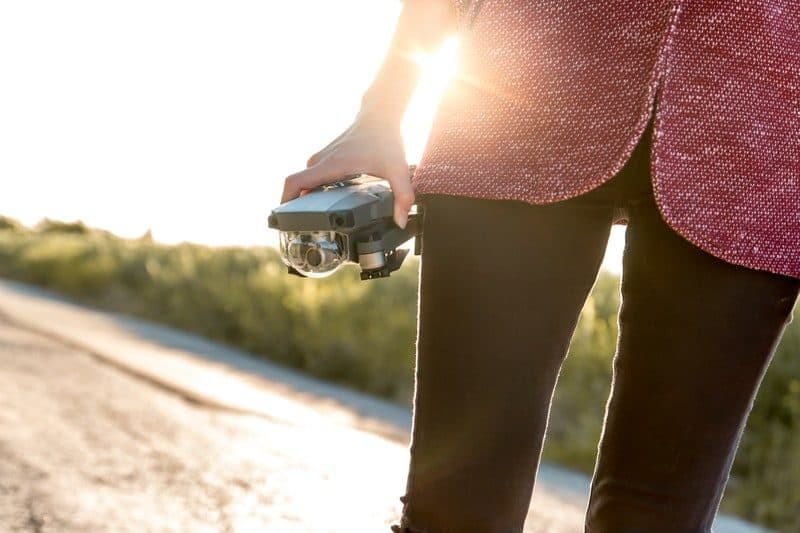 woman holding a modern drone in her hand
