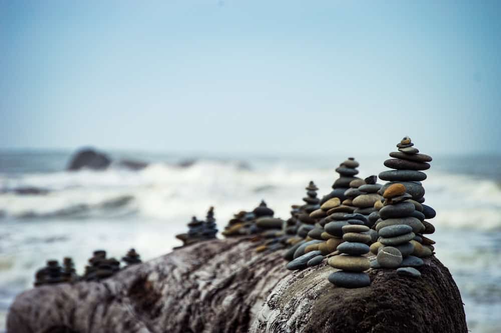 Stacked rocks at the beach with waves in the background