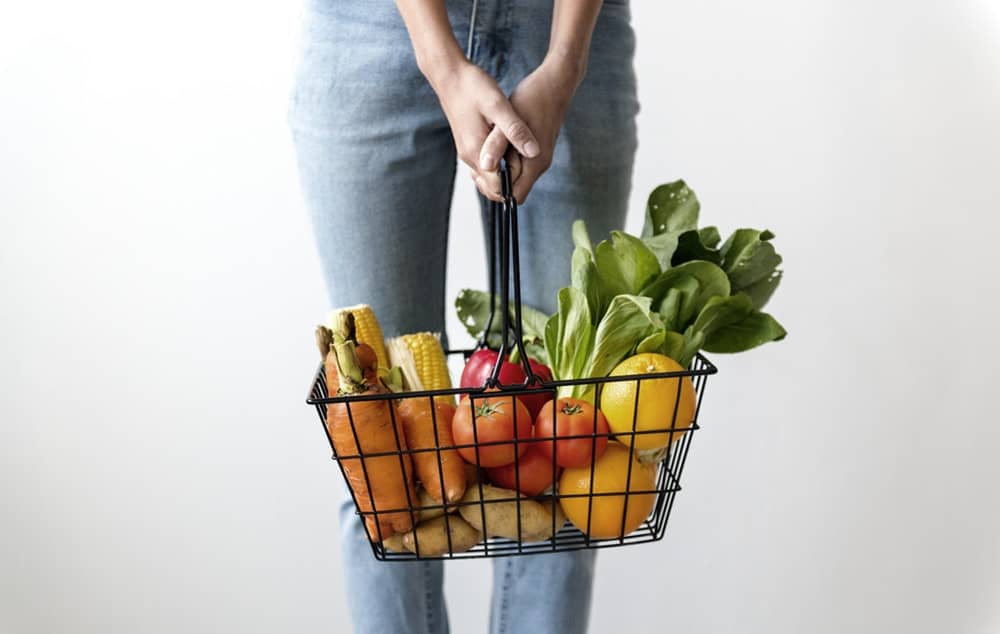 Woman Carrying Basket of Fruits and Vegetables