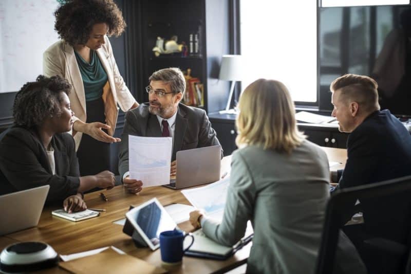 coworkers gathered inside a meeting room