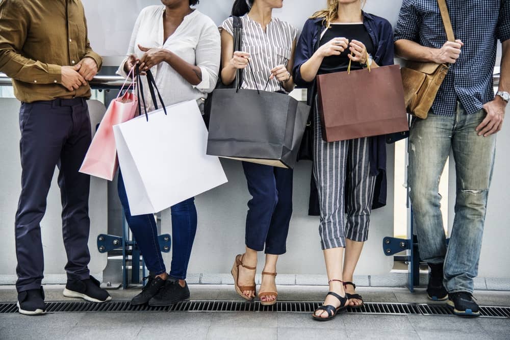 people standing and talking after shopping at the mall