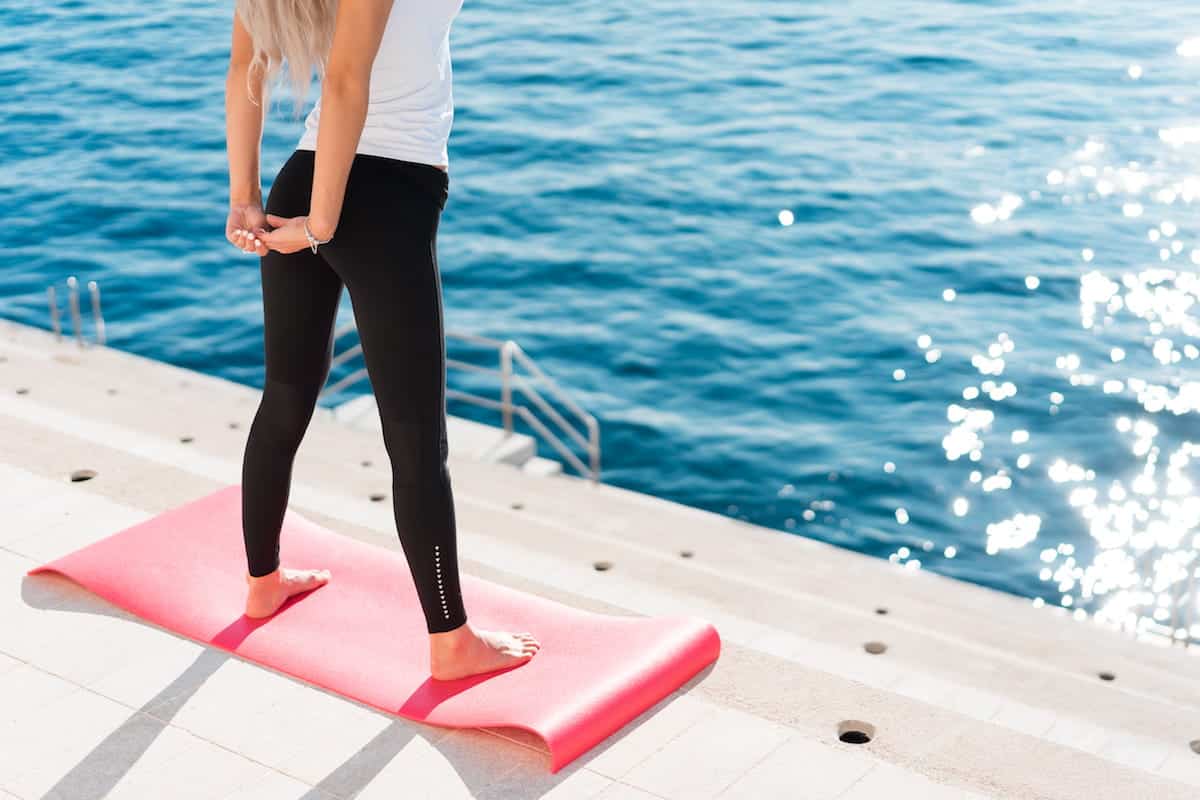 Fit Woman Stretching Her Body in Morning Yoga Routine