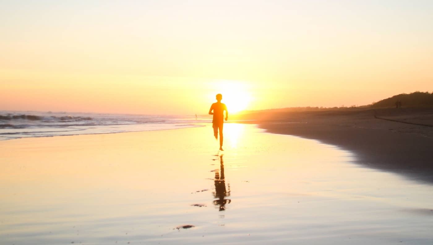 Man Running in The Morning on The Beach