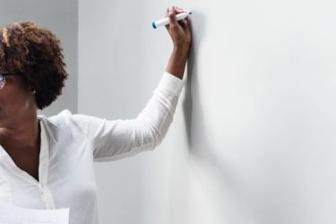 Teacher teaching her students