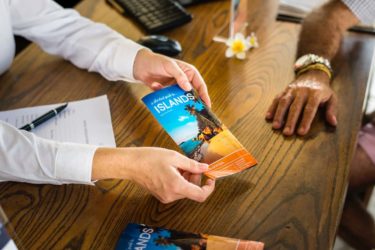Woman Showing off a Travel Brochure