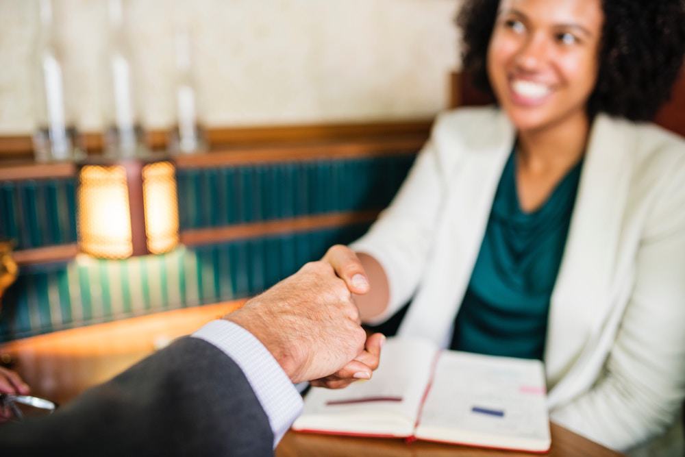 Woman shaking a lawyers hand