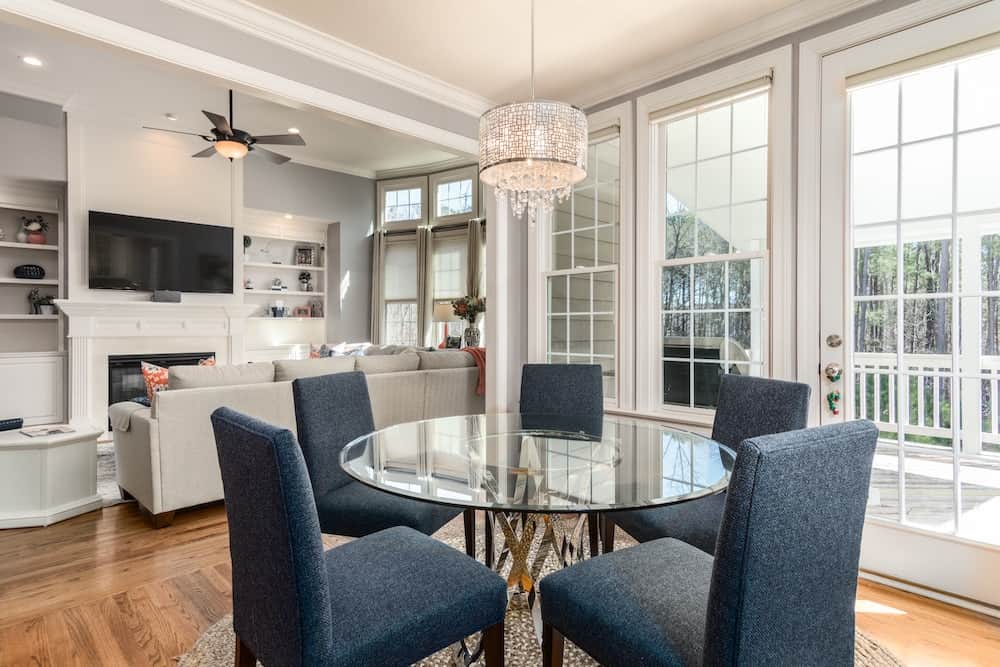 gray fabric loveseat near brown wooden table