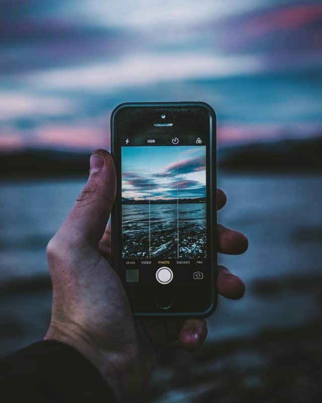 person holding space gray iPhone 5s and case