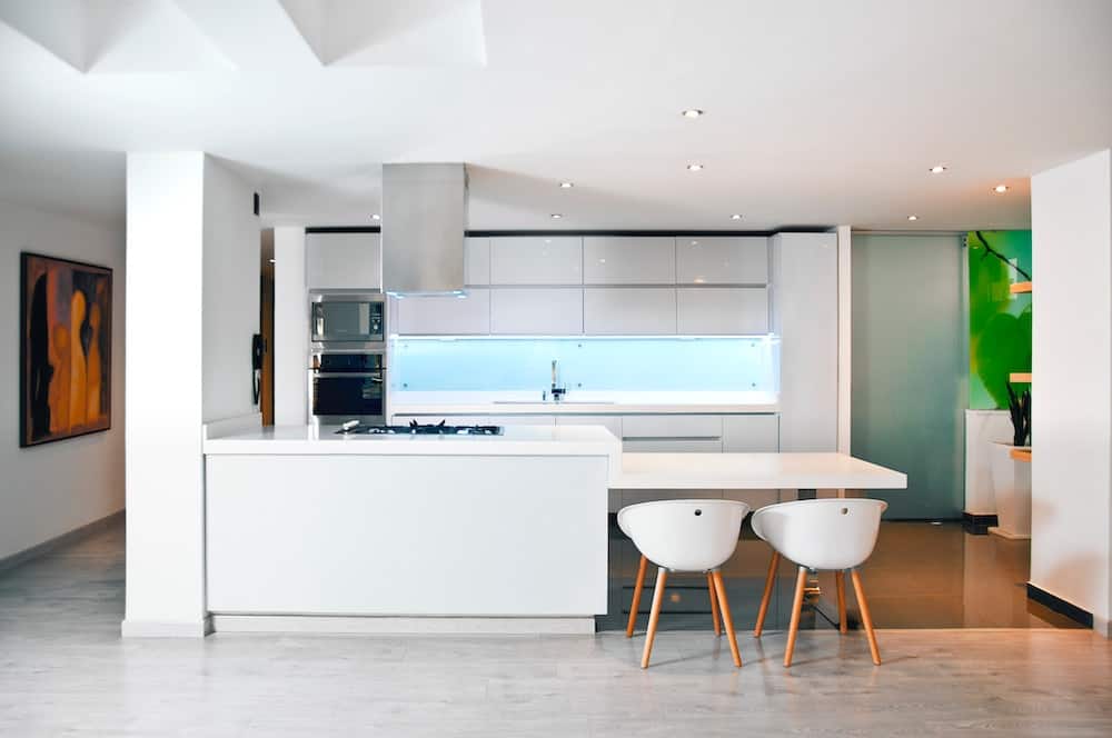 white wooden table and chairs on gray flooring