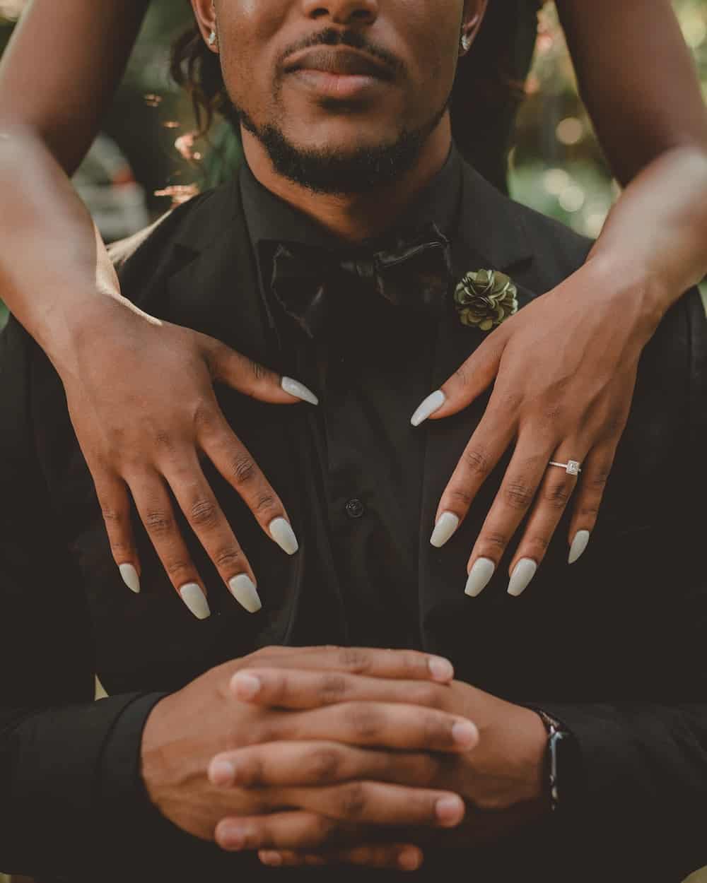 Man and woman showing off their nails