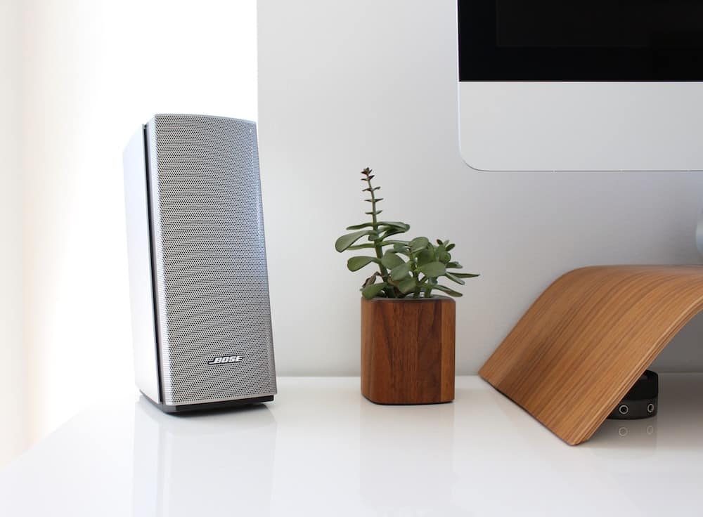 gray speaker on table near brown wooden pto