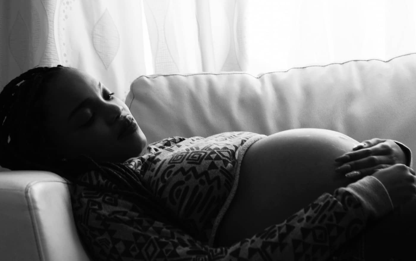 pregnant woman sleeping on the couch