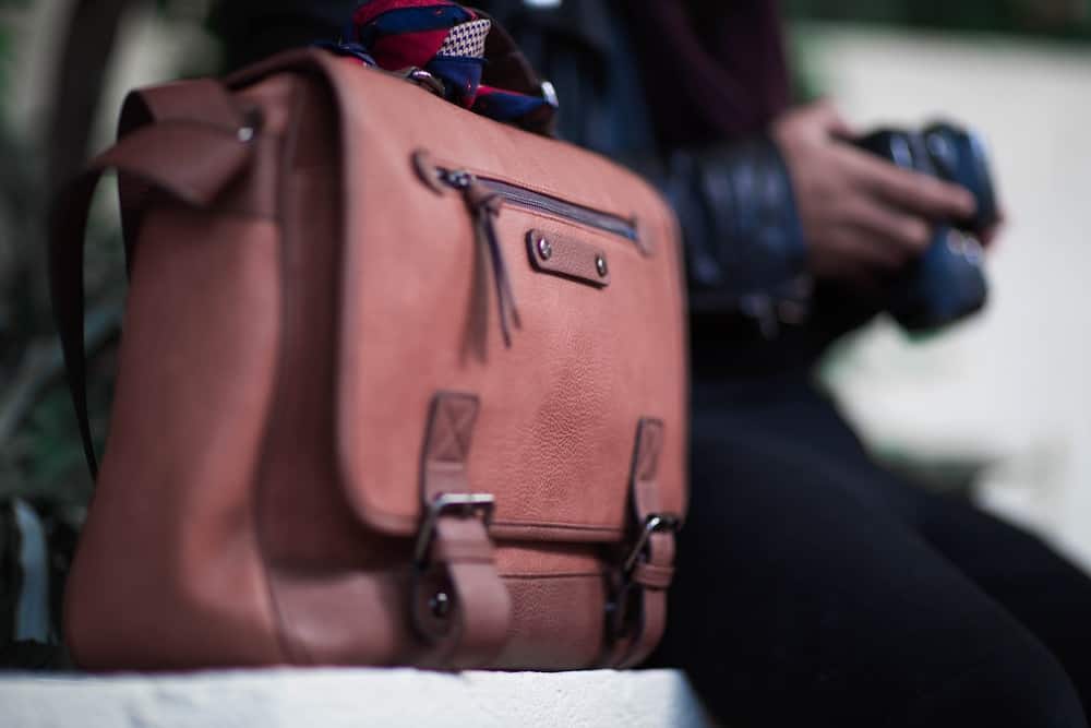 selective focus photogrtaphy of brown leather crossbody bag