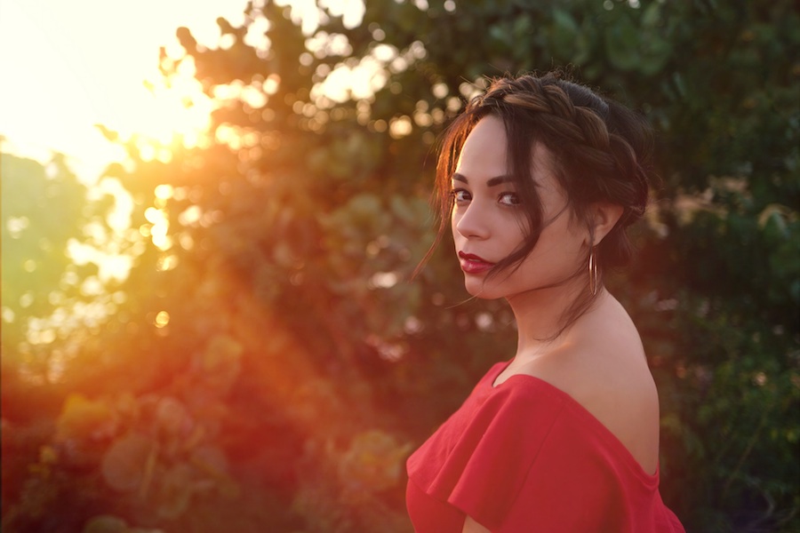 Young attractive woamn staring back during sunset