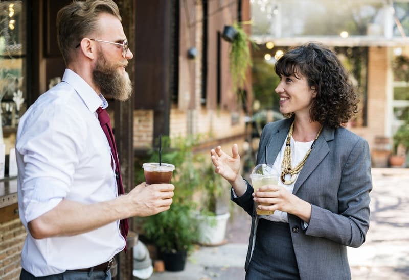 two cowrokers talking at a cafe