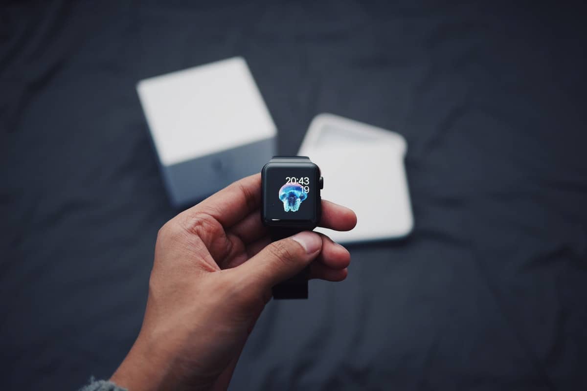 Hand holding a freshly opened Apple iWatch