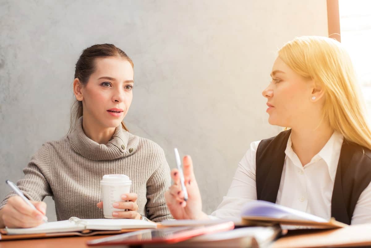 beautiful businesswomen discussing and going over ideas