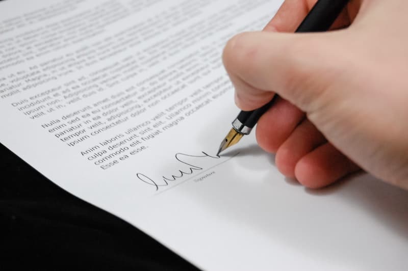 hand signing a legal contract
