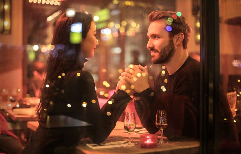 couple holding hands inside a restaurant