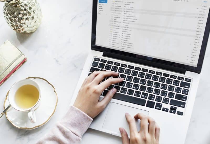 woman sending an email using her macbook pro