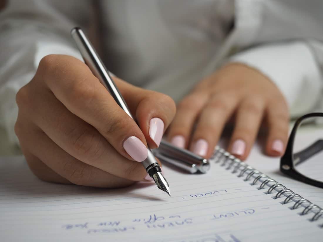 Woman writing in her notebook