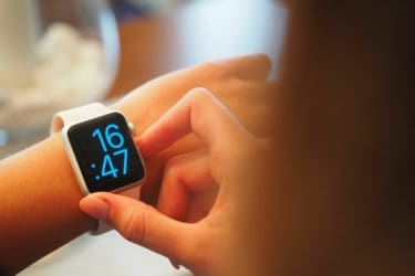 Young woman checking her apple watch