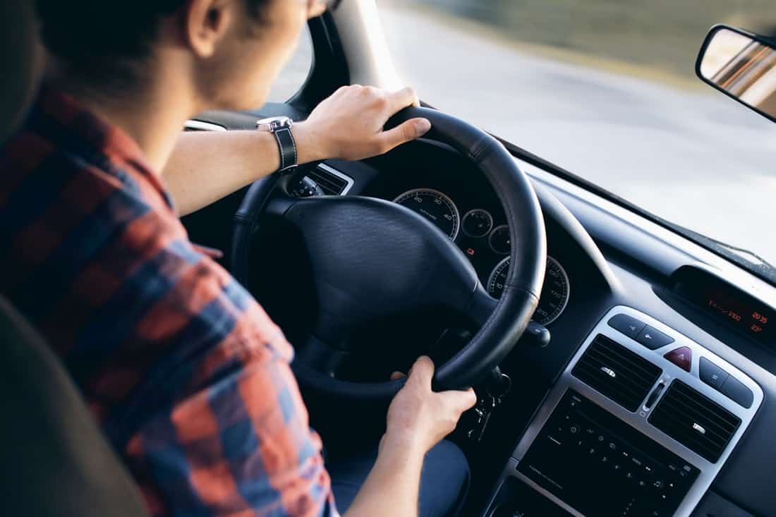 adult driving a vehicle