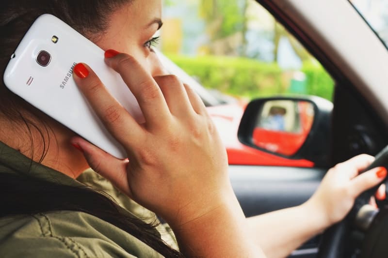 woman talking on her cell phone while driving