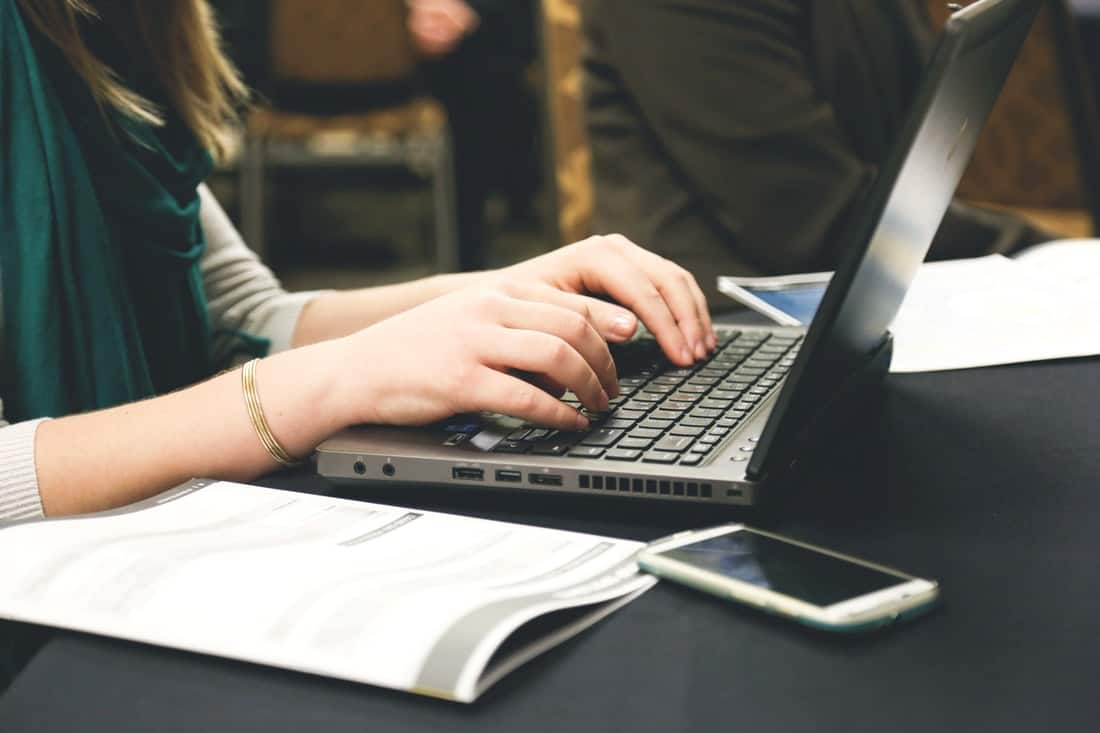 woman typing an essay for her college class