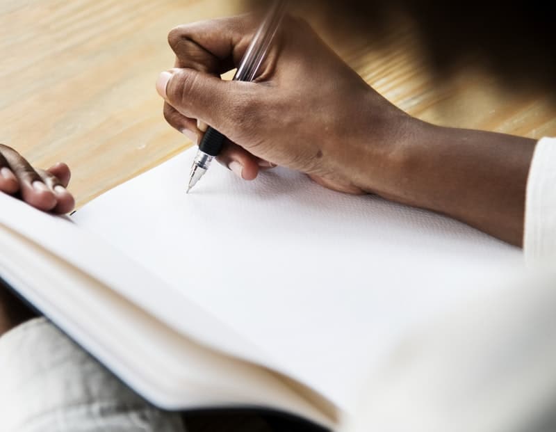 woman writing in her notebook