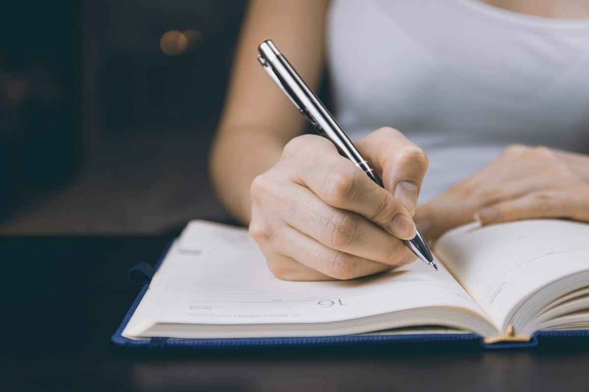 Woman getting ready to write in her notebook