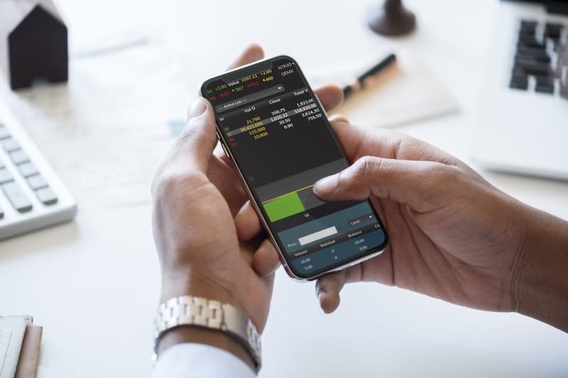 man using a smartphone to check stock quotes