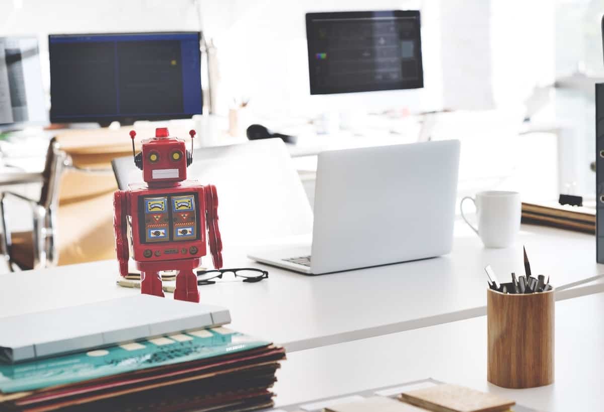 red toy robot at a modern startup workspace