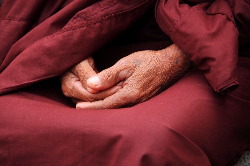 aged asian monk meditating