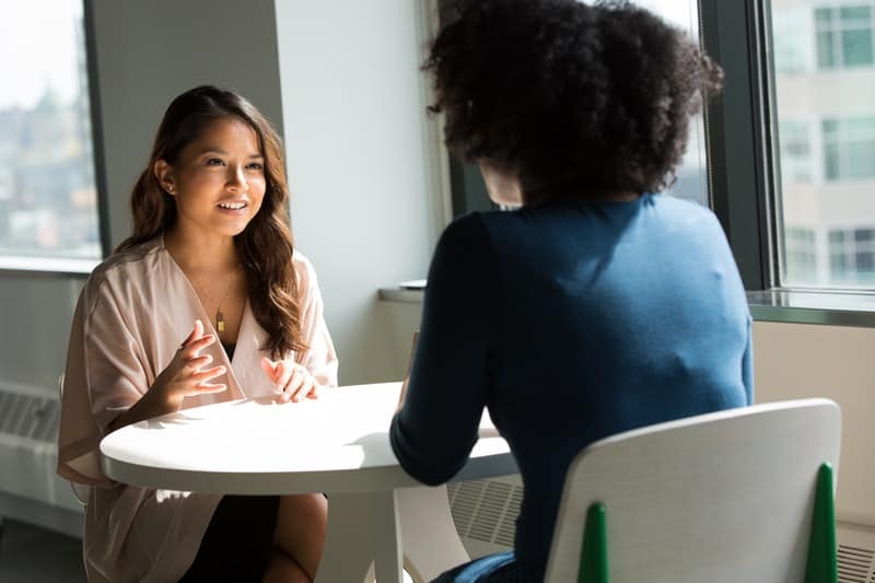 two women discussing company policies