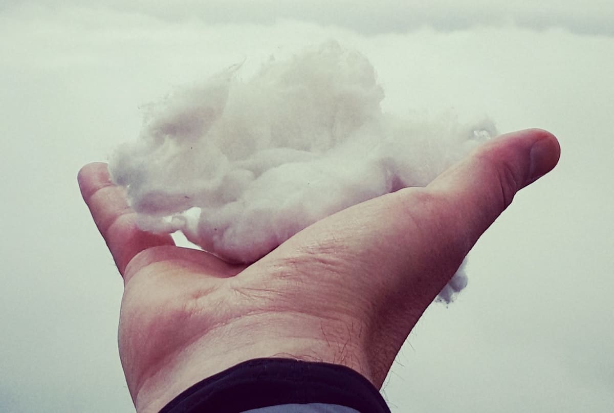 Man Holding a small cloud in his hand