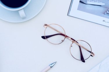 Reading Glasses on a White Desk