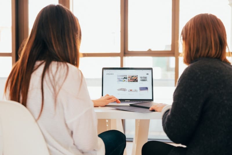 Two Women Coming up with search queries